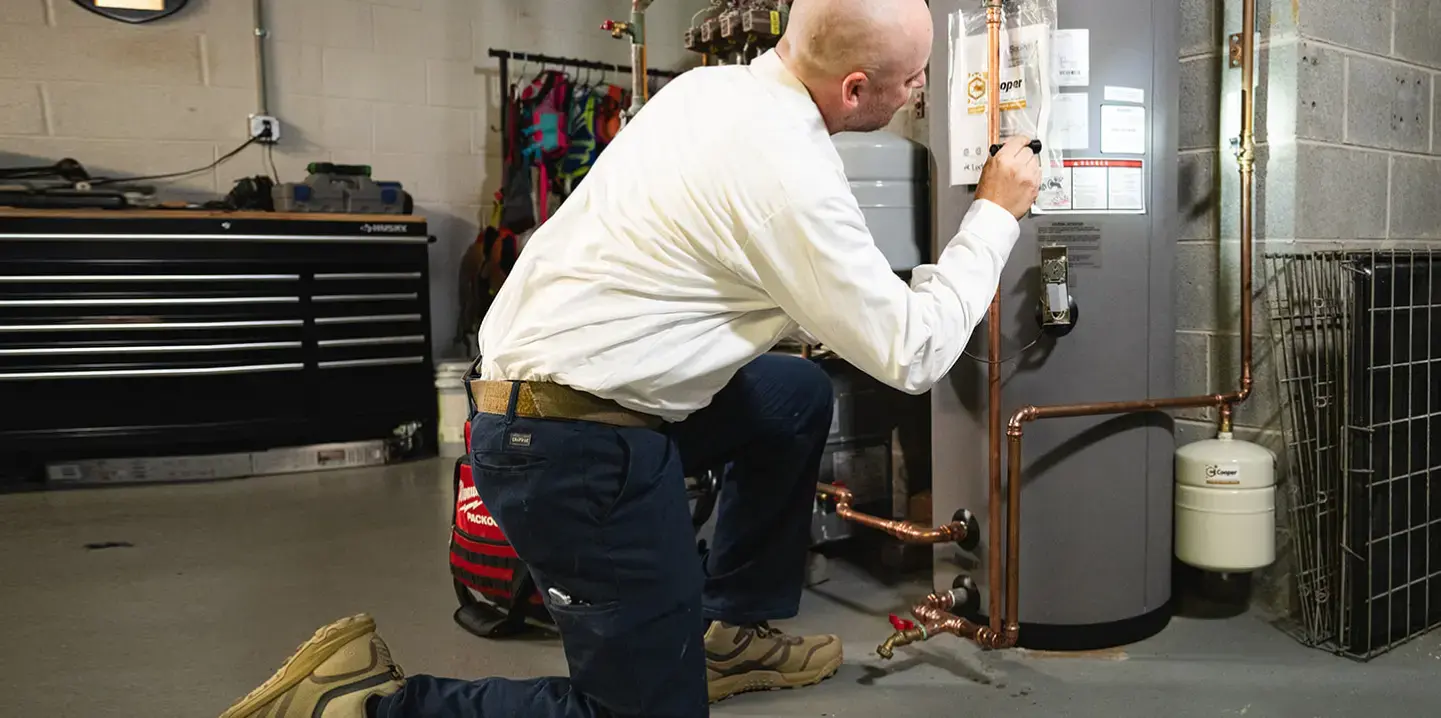 technician fixing a boiler