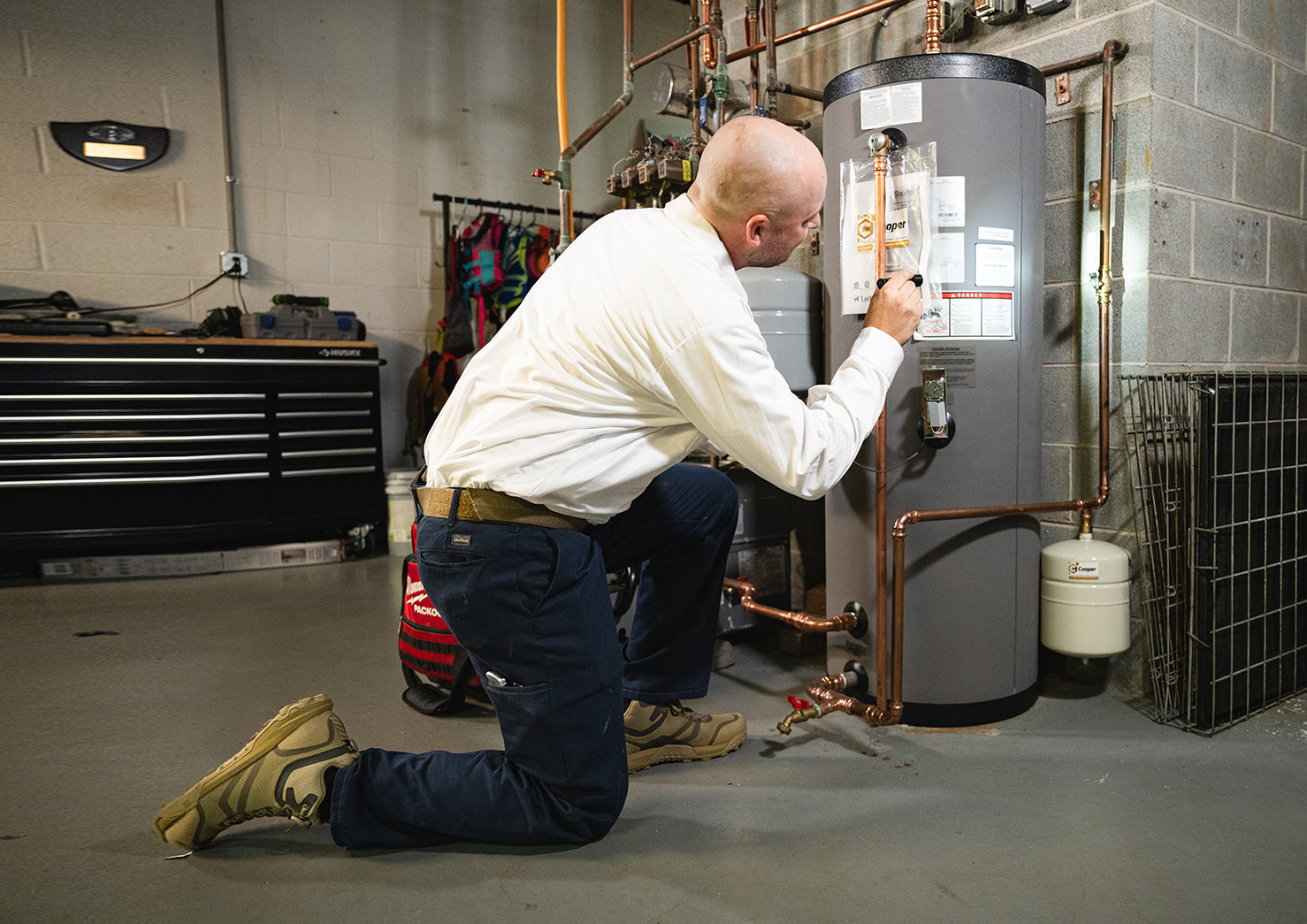 technician fixing a boiler