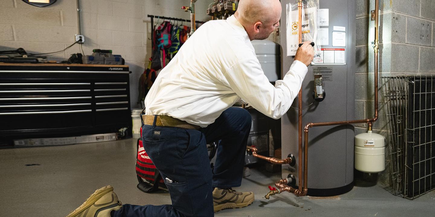 technician fixing a boiler
